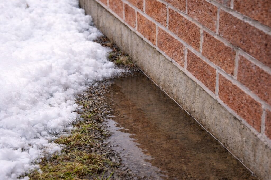 Water pooling near foundation during a thaw in London Ontario