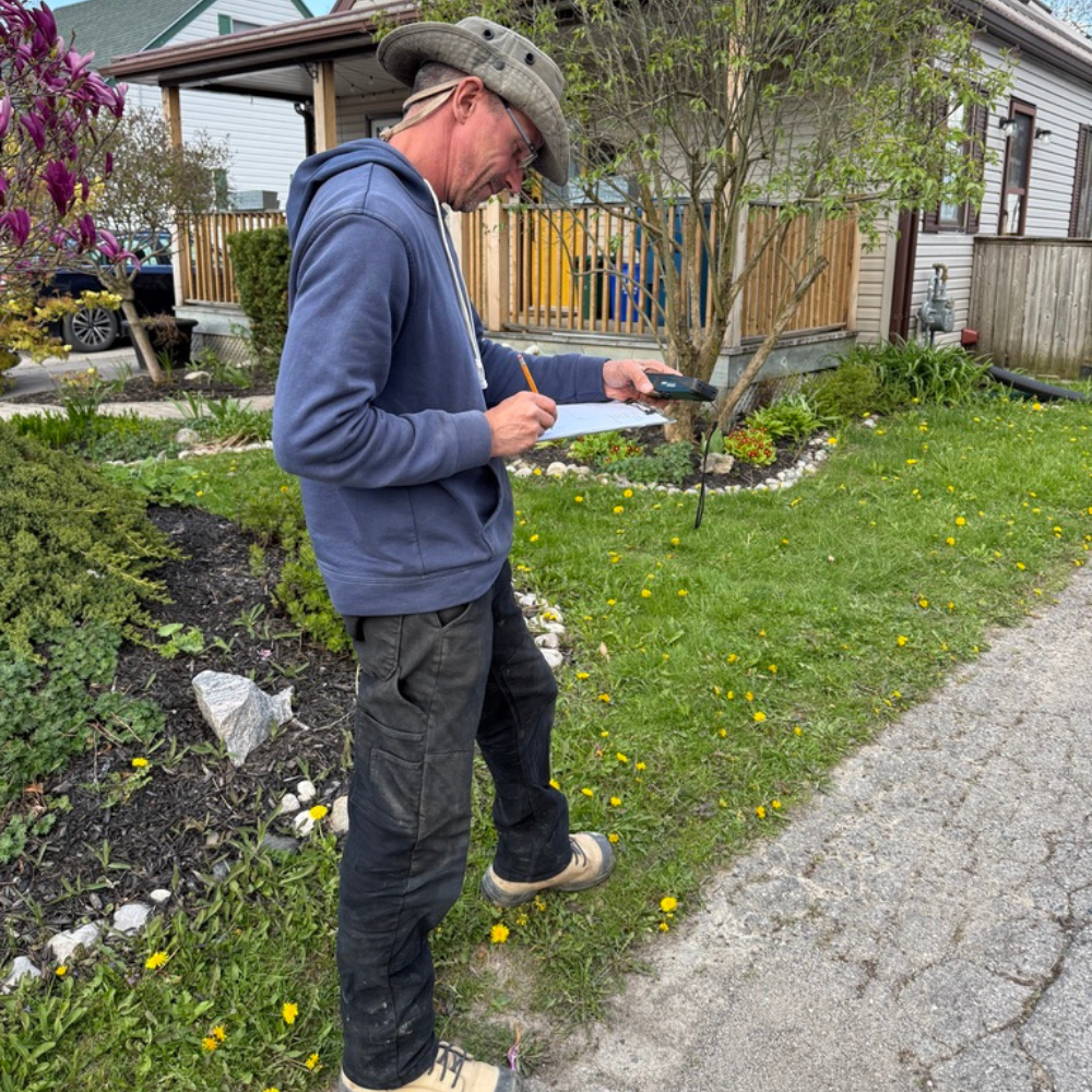 Chris conducting an on-site foundation drainage assessment at a Stratford, Ontario home